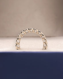 Angled view of oval lab grown diamond eternity band with eternity setting