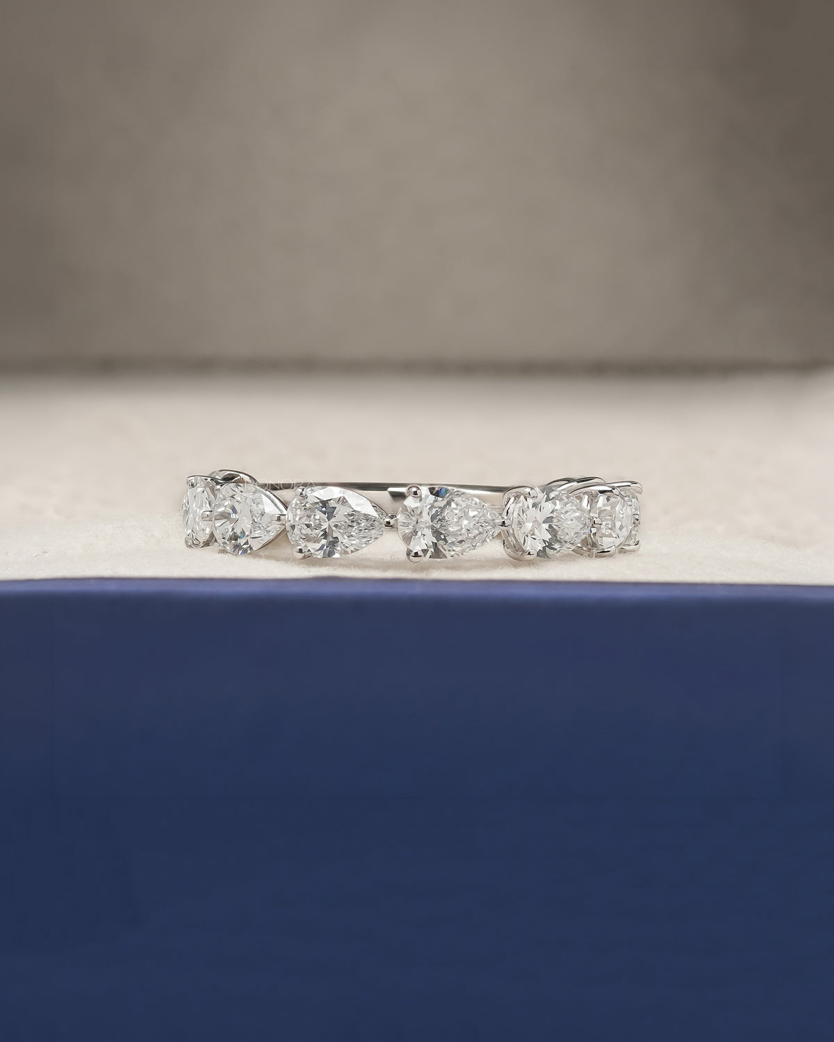 Sylvie pear lab grown diamond eternity band in white gold inside Ronora box
