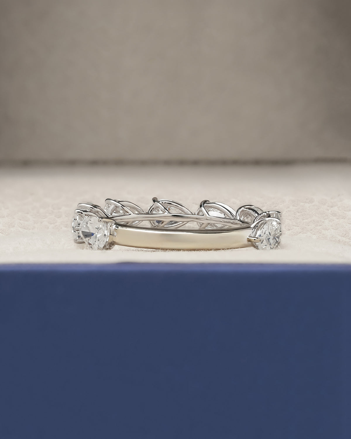 Side profile of pear lab grown diamond eternity band showing ring setting