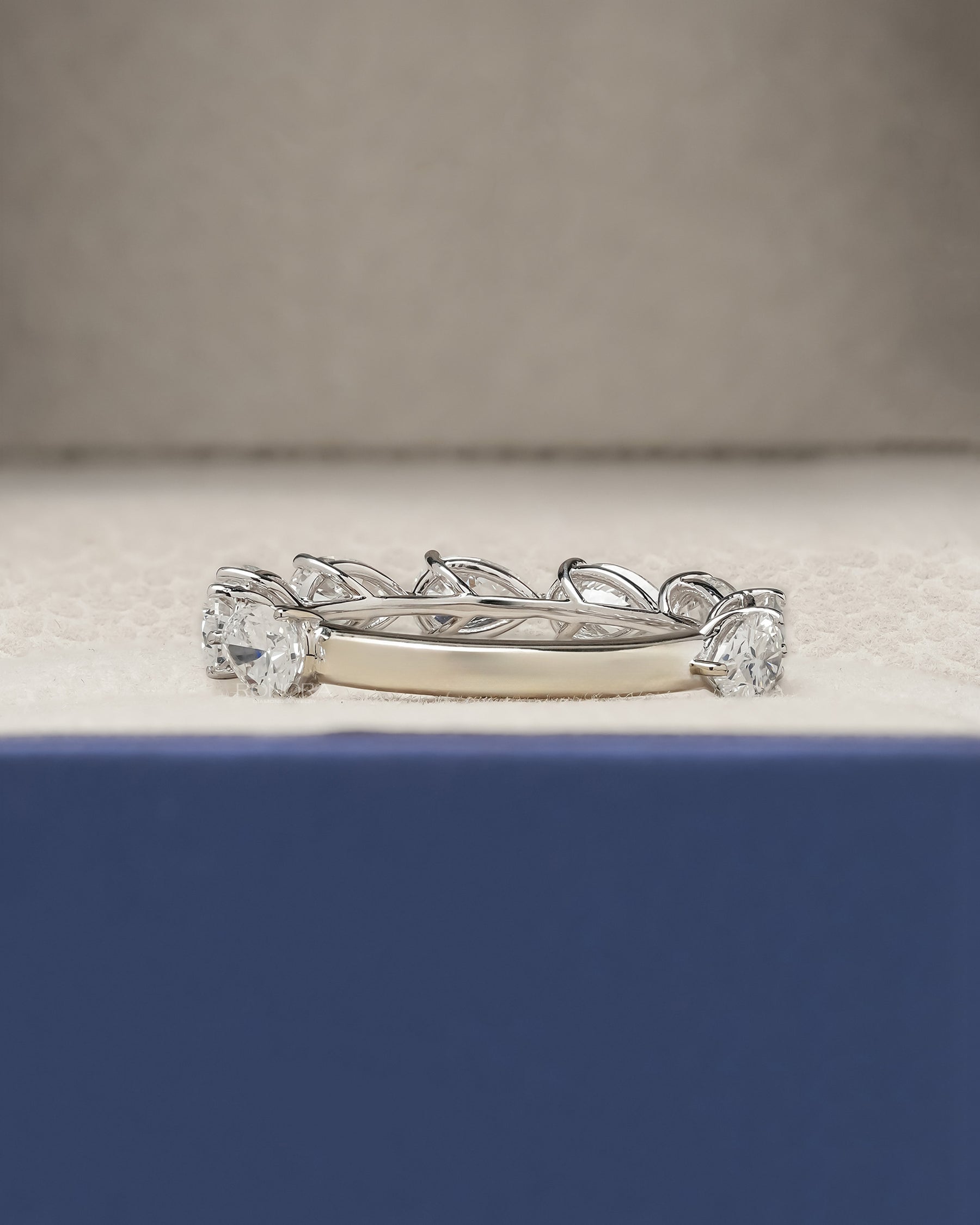 Side profile of pear lab grown diamond eternity band showing ring setting
