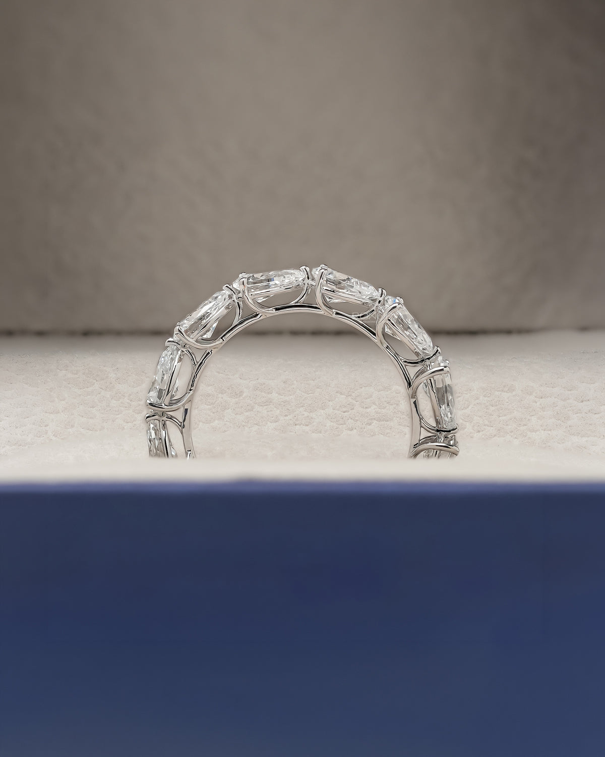 Angled view of pear lab grown diamond eternity band with eternity setting