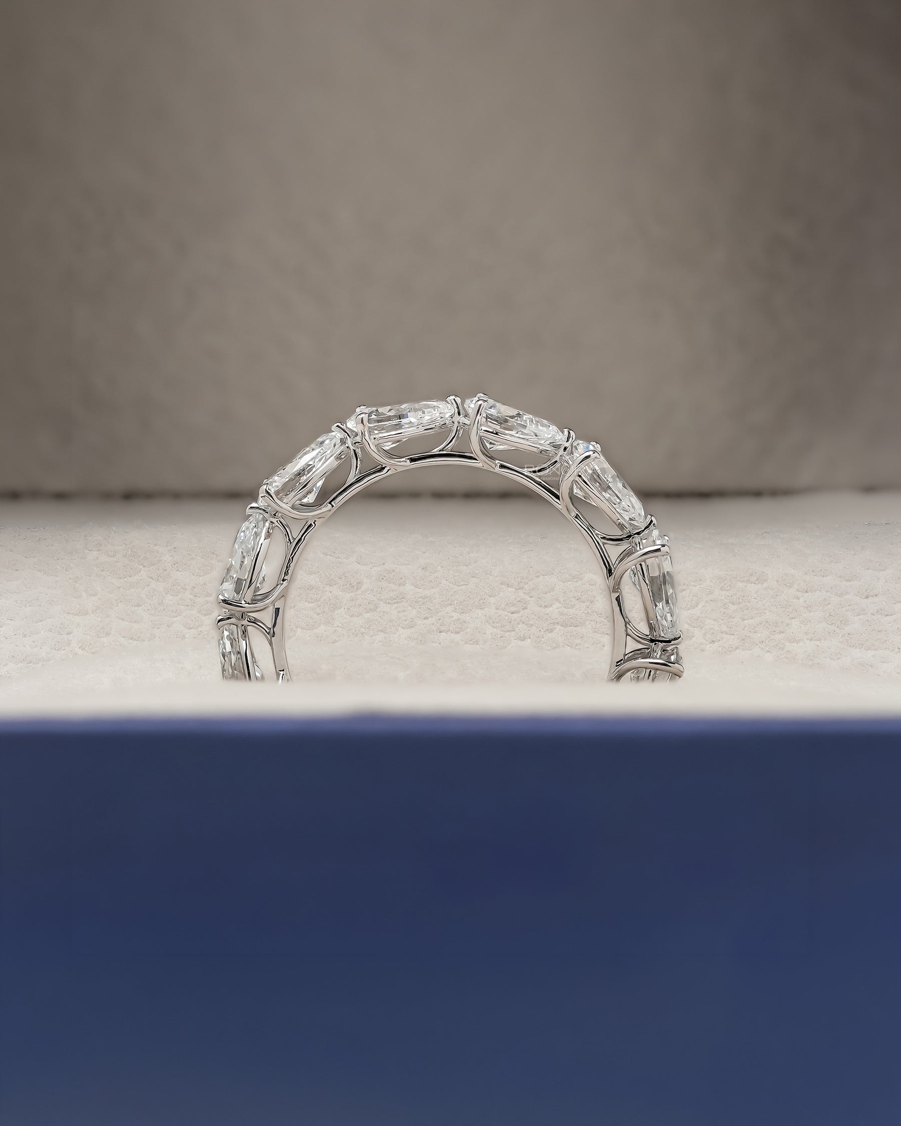 Angled view of pear lab grown diamond eternity band with eternity setting