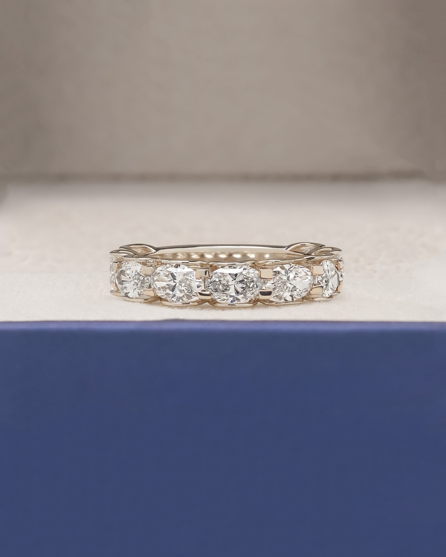Marina oval lab grown diamond eternity band in yellow gold inside Ronora box
