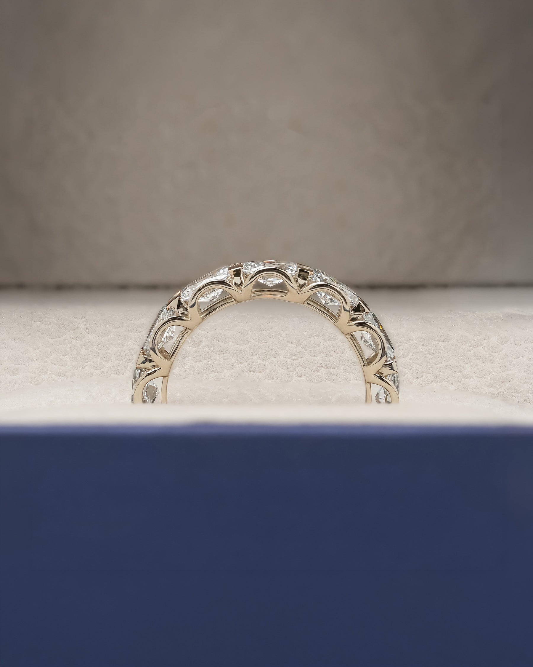 Side profile of oval lab grown diamond eternity band showing ring setting