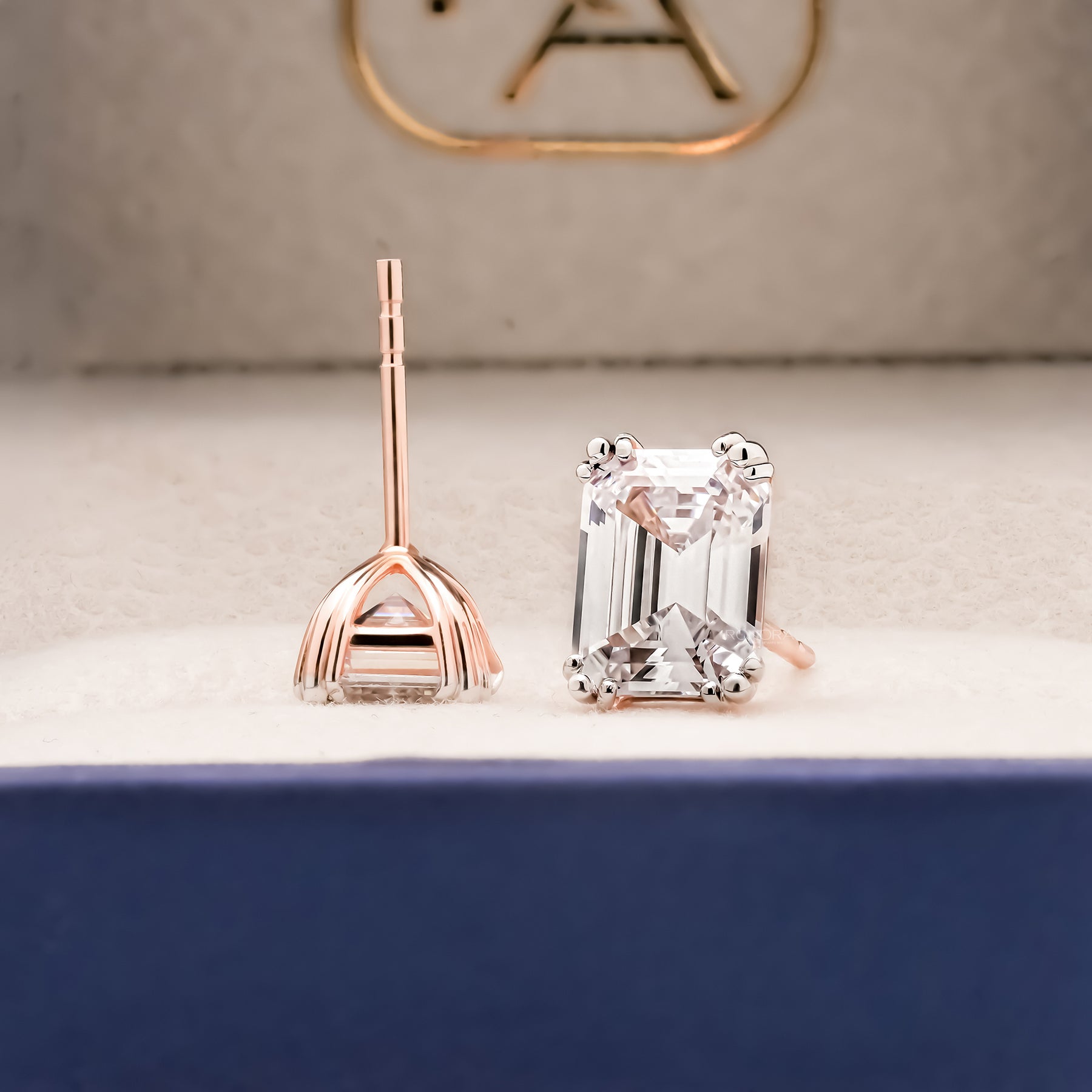 Side and front view of emerald lab grown diamond stud earrings with post backs