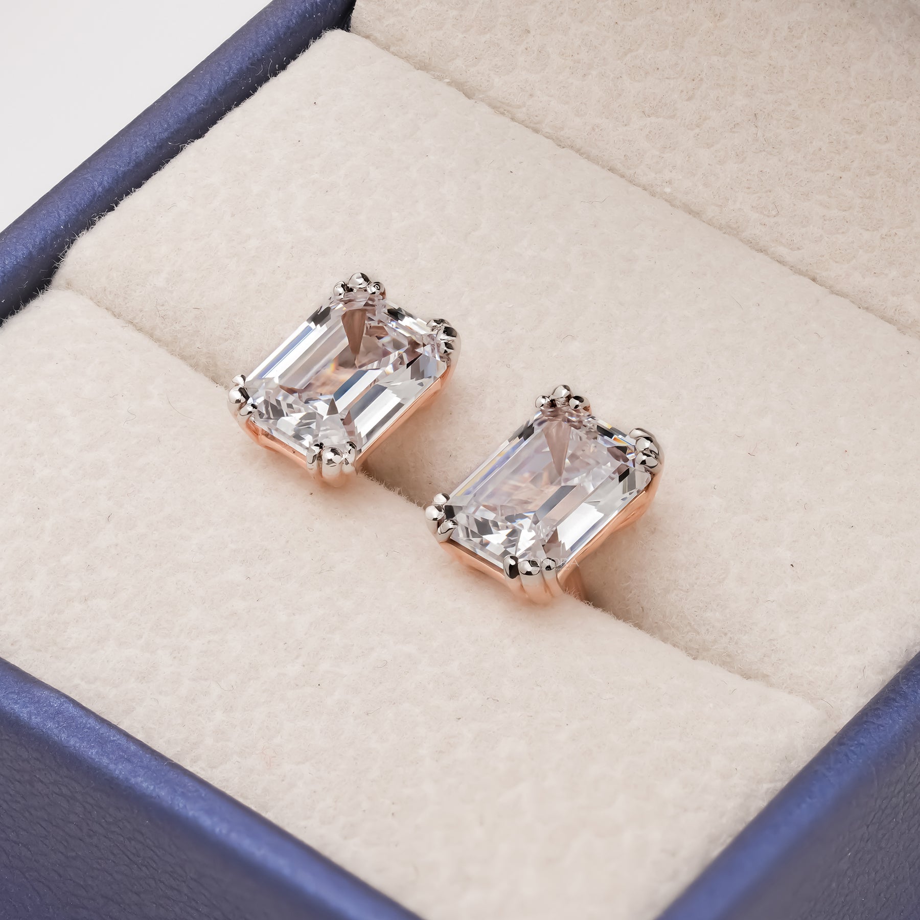 Emerald lab grown diamond stud earrings displayed inside Ronora box
