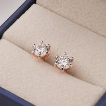 Angled view of round lab grown diamond stud earrings in Ronora box