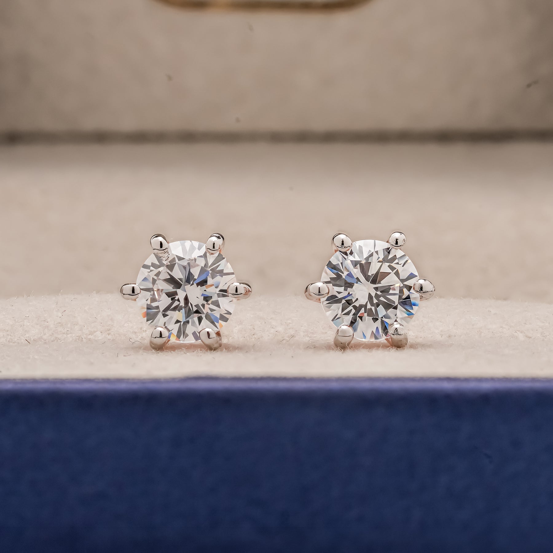 Front view of round lab grown diamond stud earrings inside Ronora box