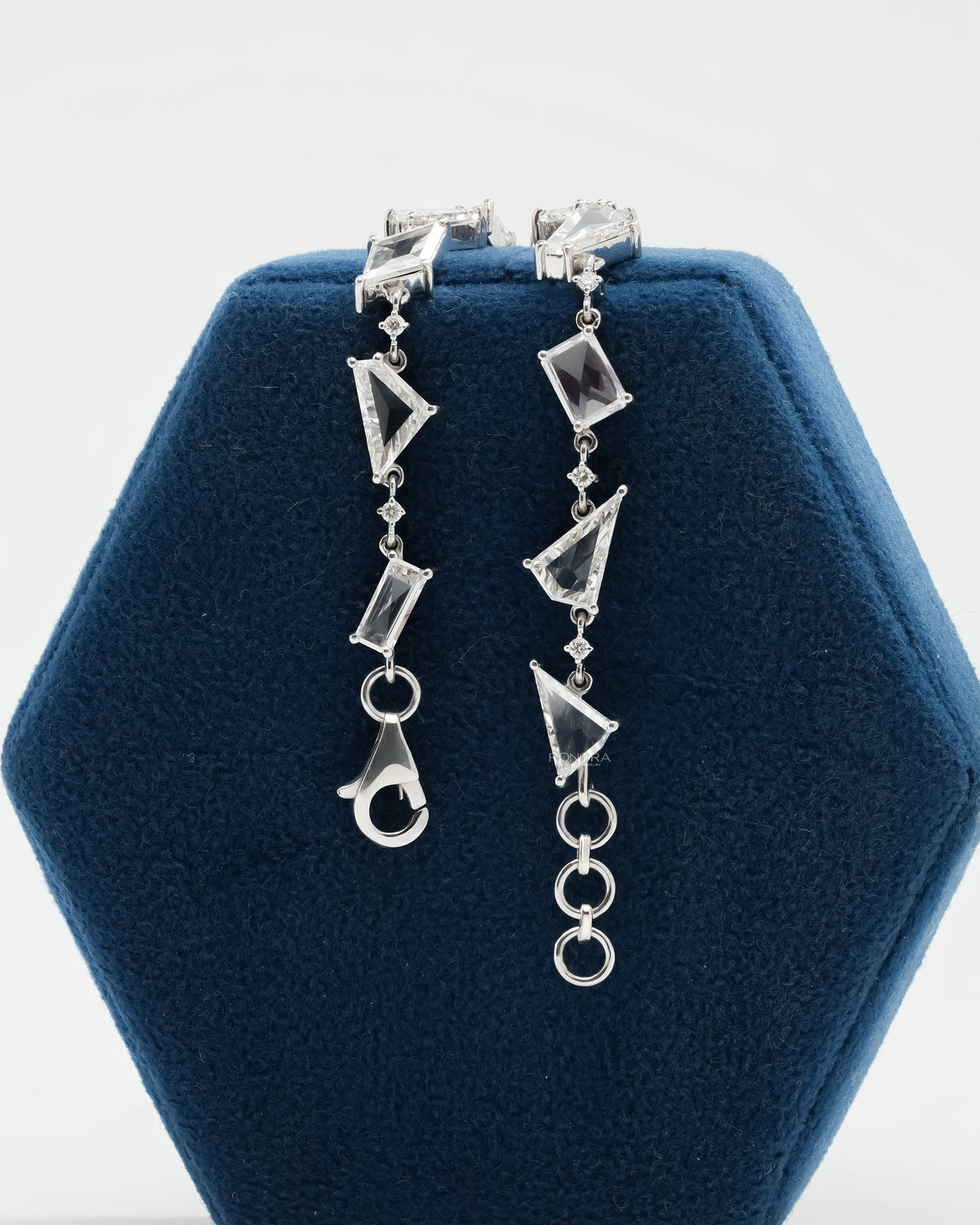 Multi shape lab grown diamond bracelet displayed on a blue Ronora stand