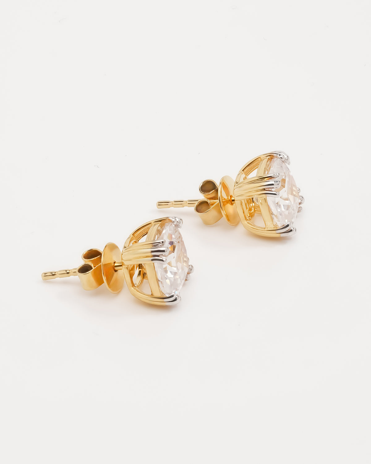 Cushion cut lab grown diamond earrings in yellow gold, side view of the basket setting and posts