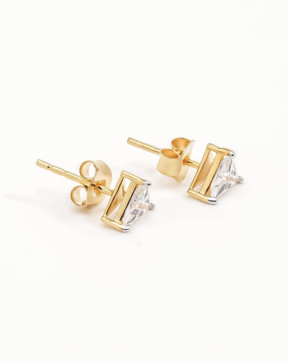 Trillion cut lab grown diamond earrings in yellow gold, angled view of the posts and butterfly backs