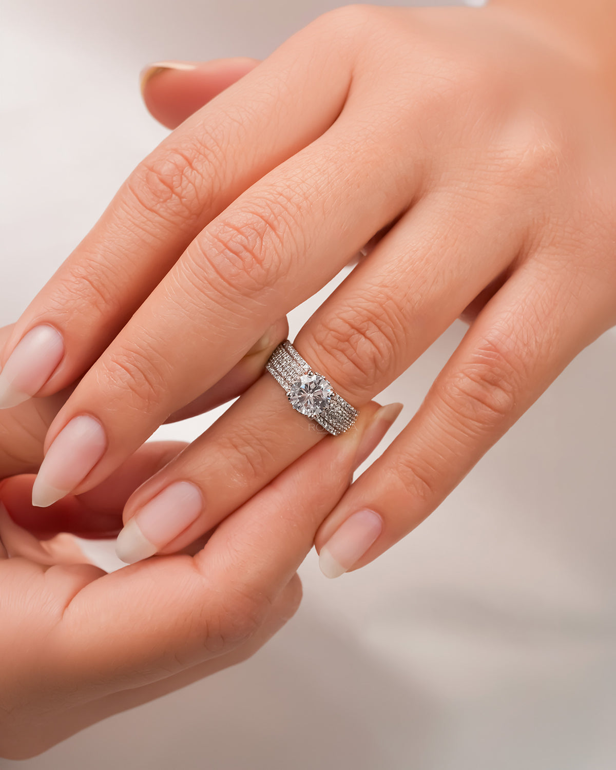 round moissanite pave ring worn on hand in rose gold