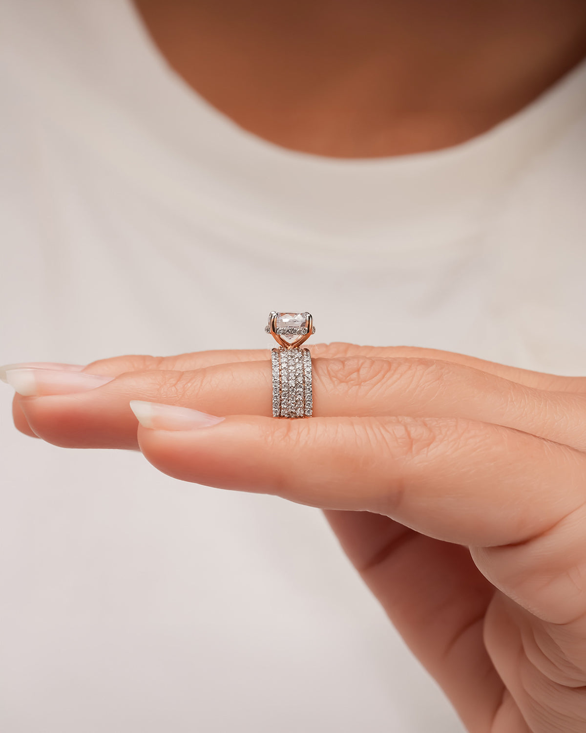 round moissanite pave ring worn with luxury styling in rose gold
