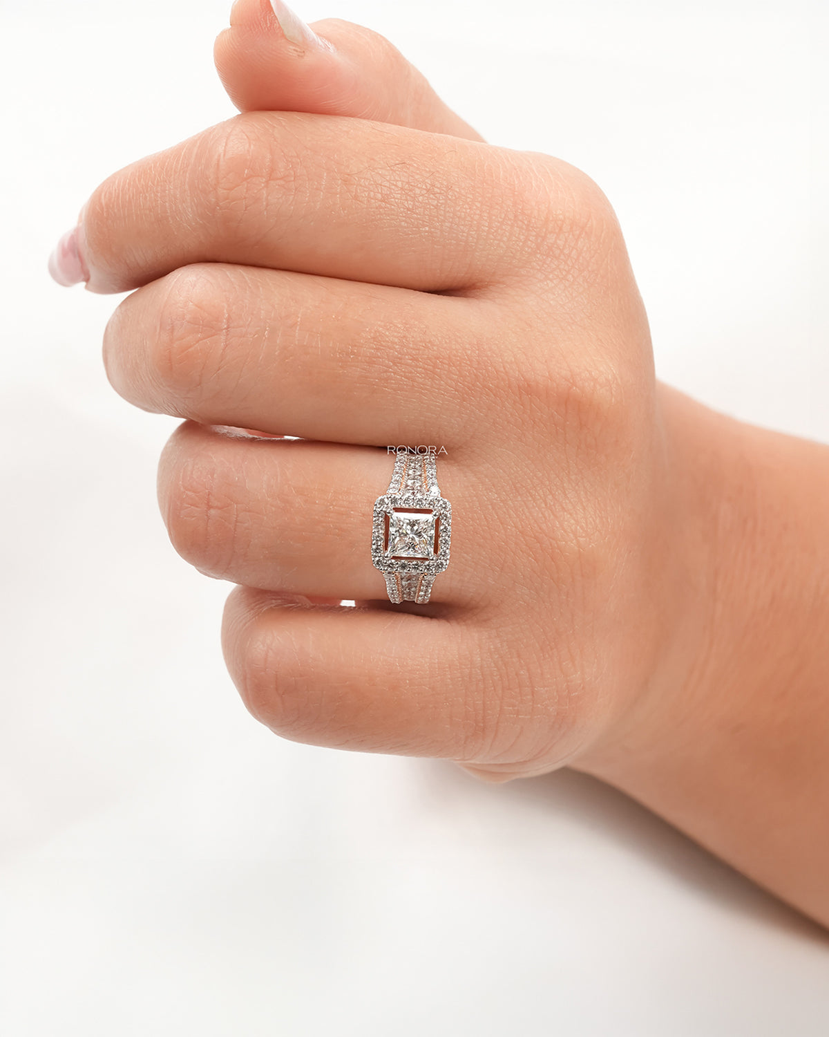 princess lab grown diamond halo ring worn on hand in rose gold