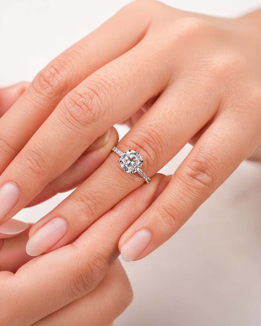 round moissanite pave ring worn on hand in rose gold