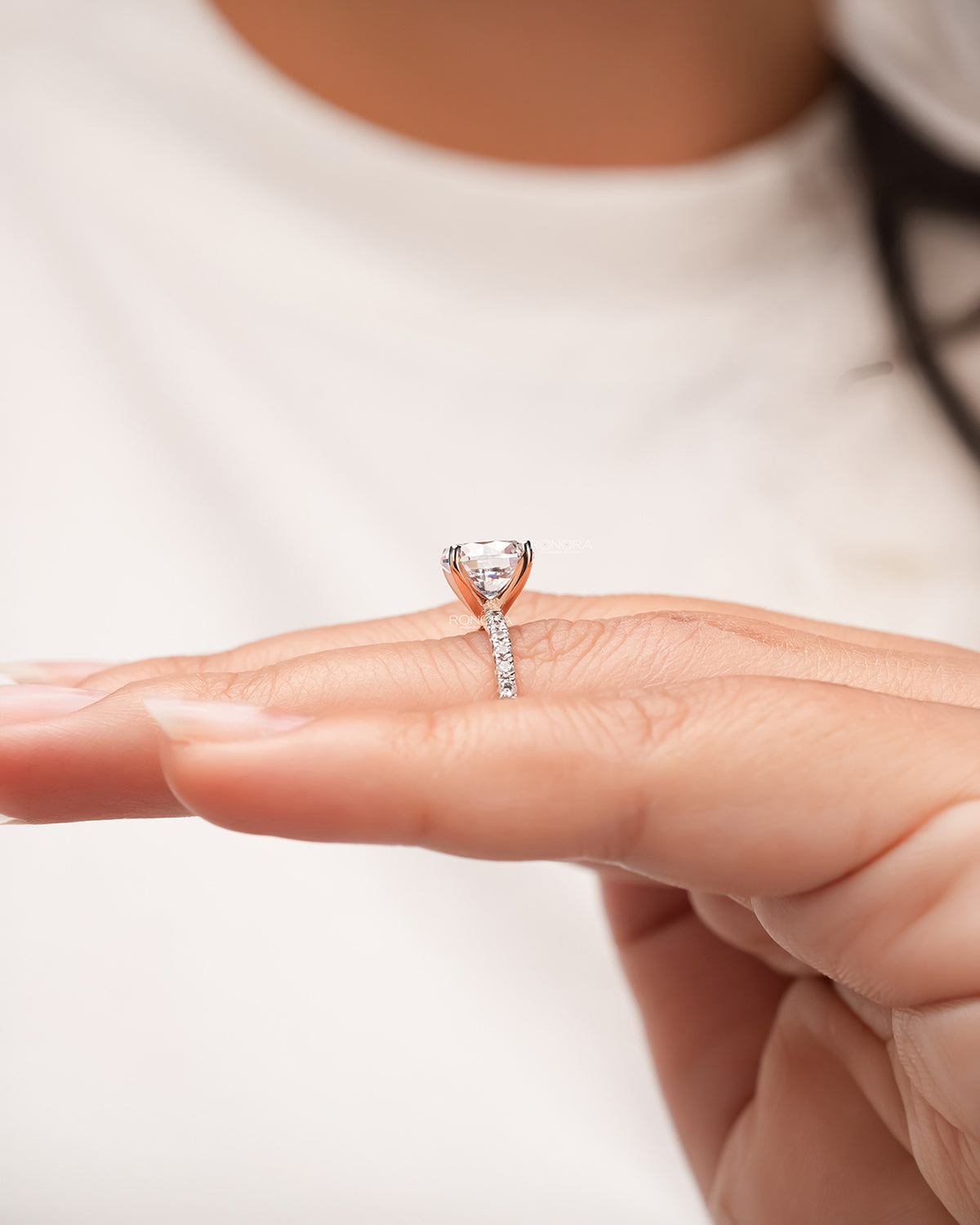 round moissanite pave ring worn with luxury styling in rose gold