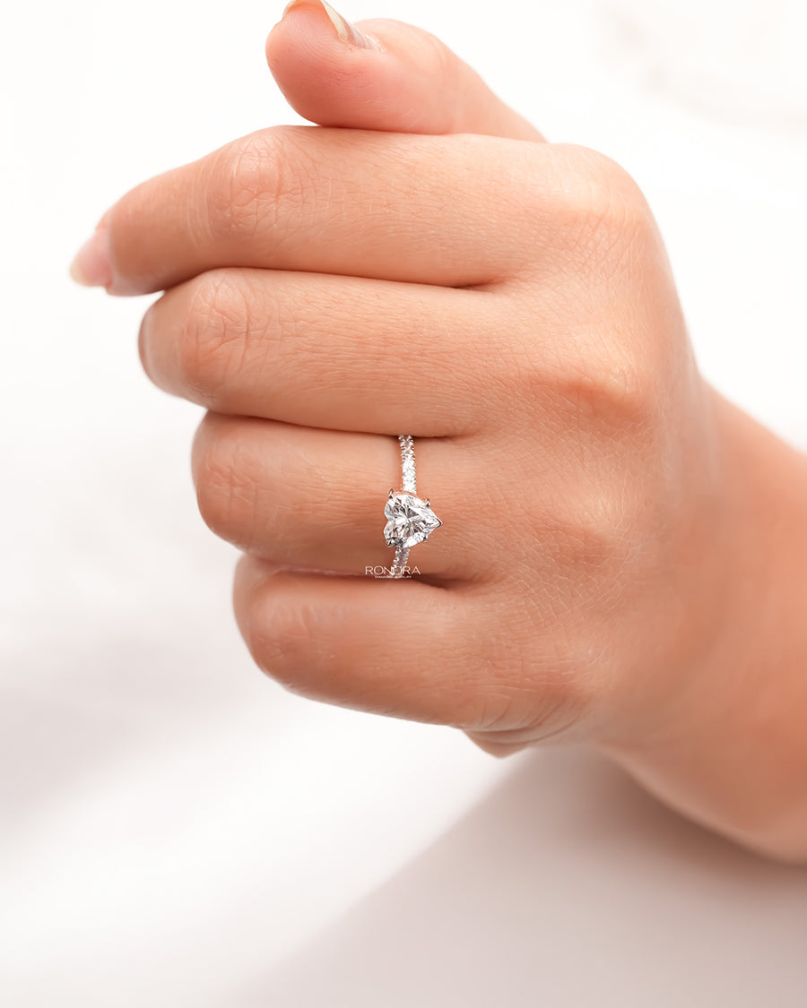 heart moissanite pave ring worn on hand in rose gold