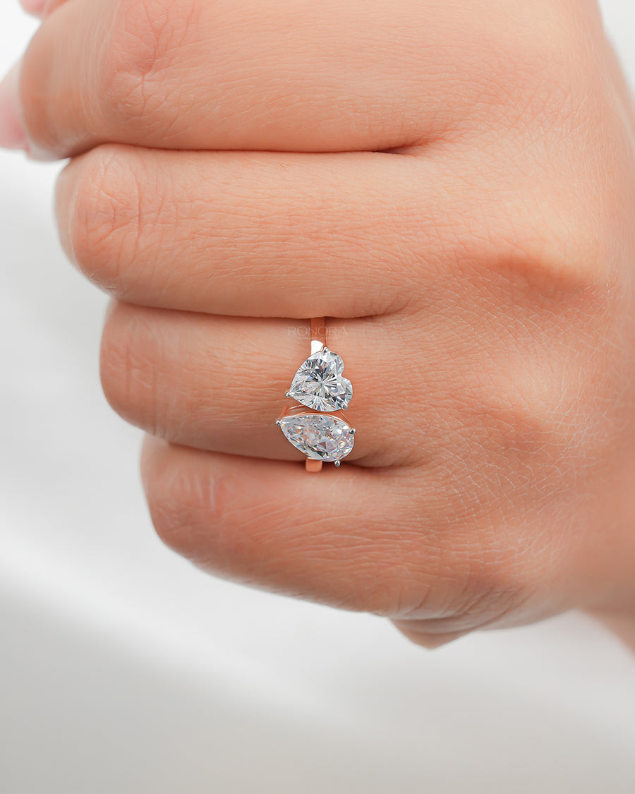 heart pear moissanite toi et moi ring worn on hand in rose gold