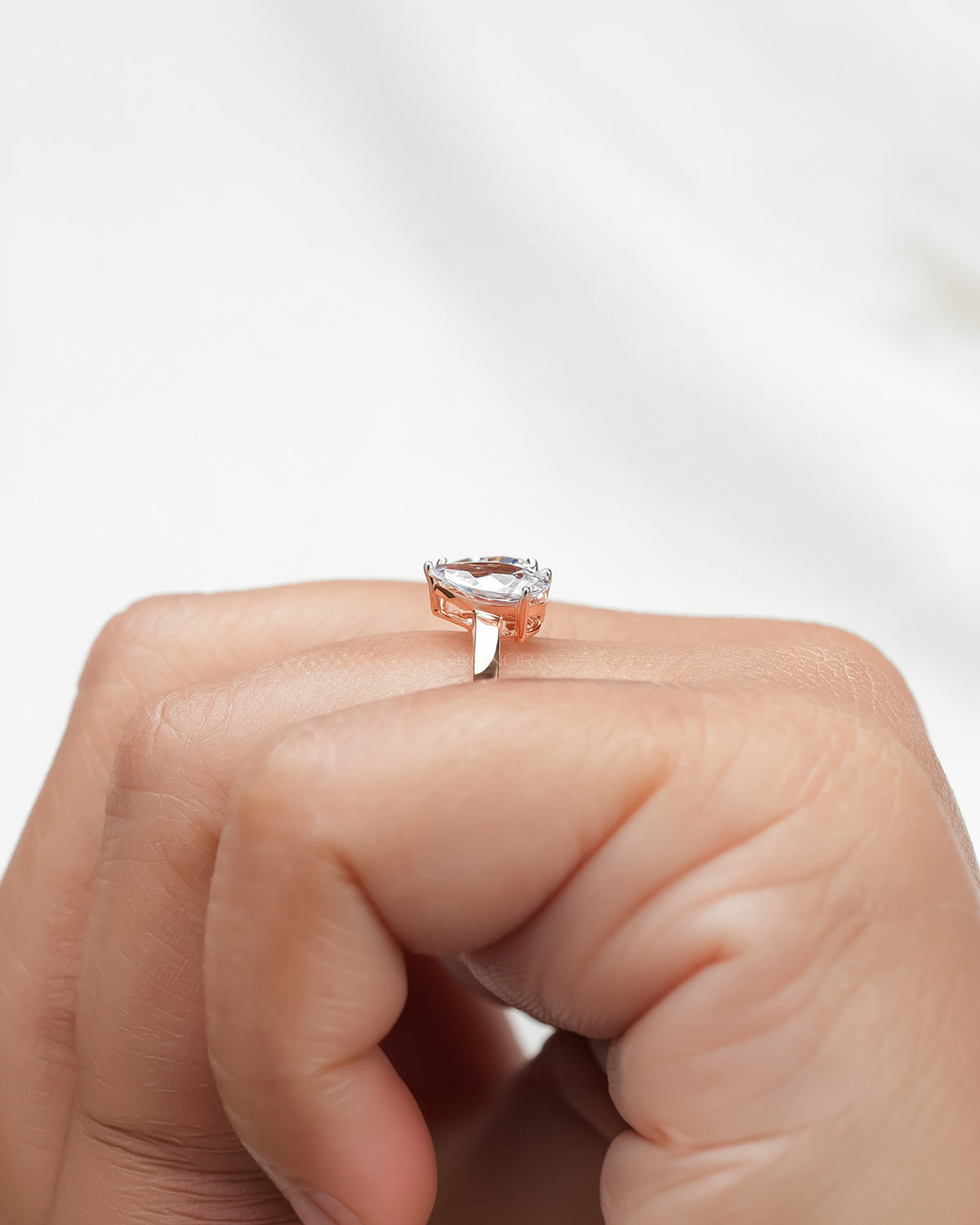 heart pear moissanite toi et moi ring worn with luxury styling in rose gold