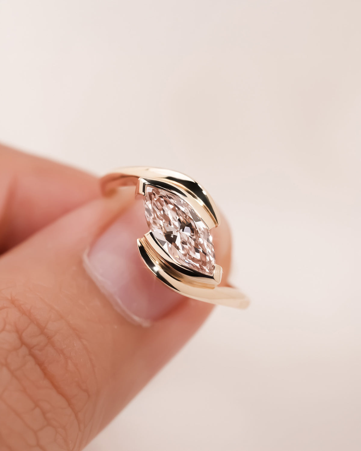 Detail view of pink marquise lab grown diamond twist ring in rose gold