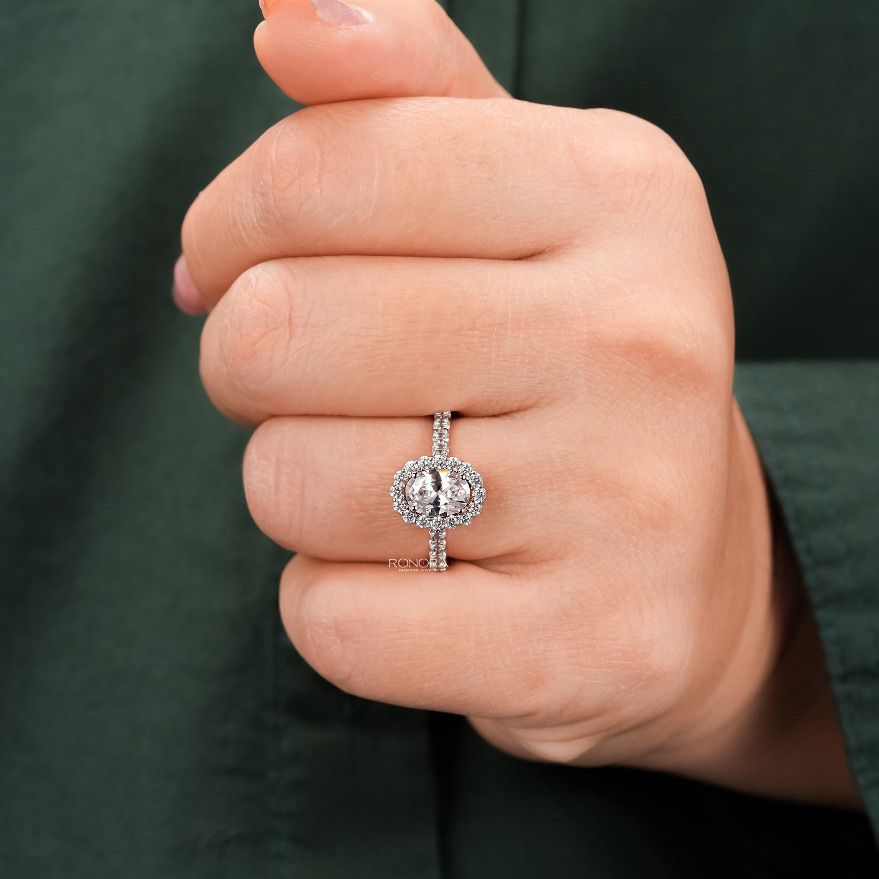 Angled view of oval moissanite halo ring with halo pave setting