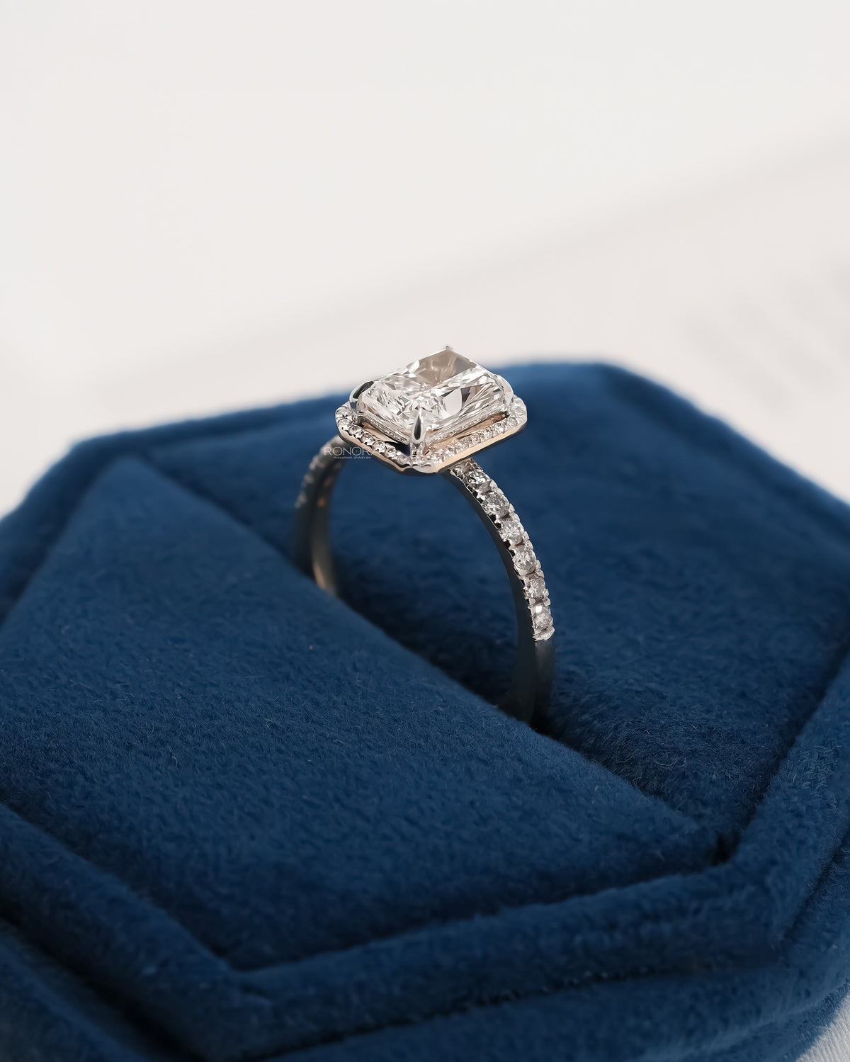 Side profile of radiant lab grown diamond halo ring showing ring setting