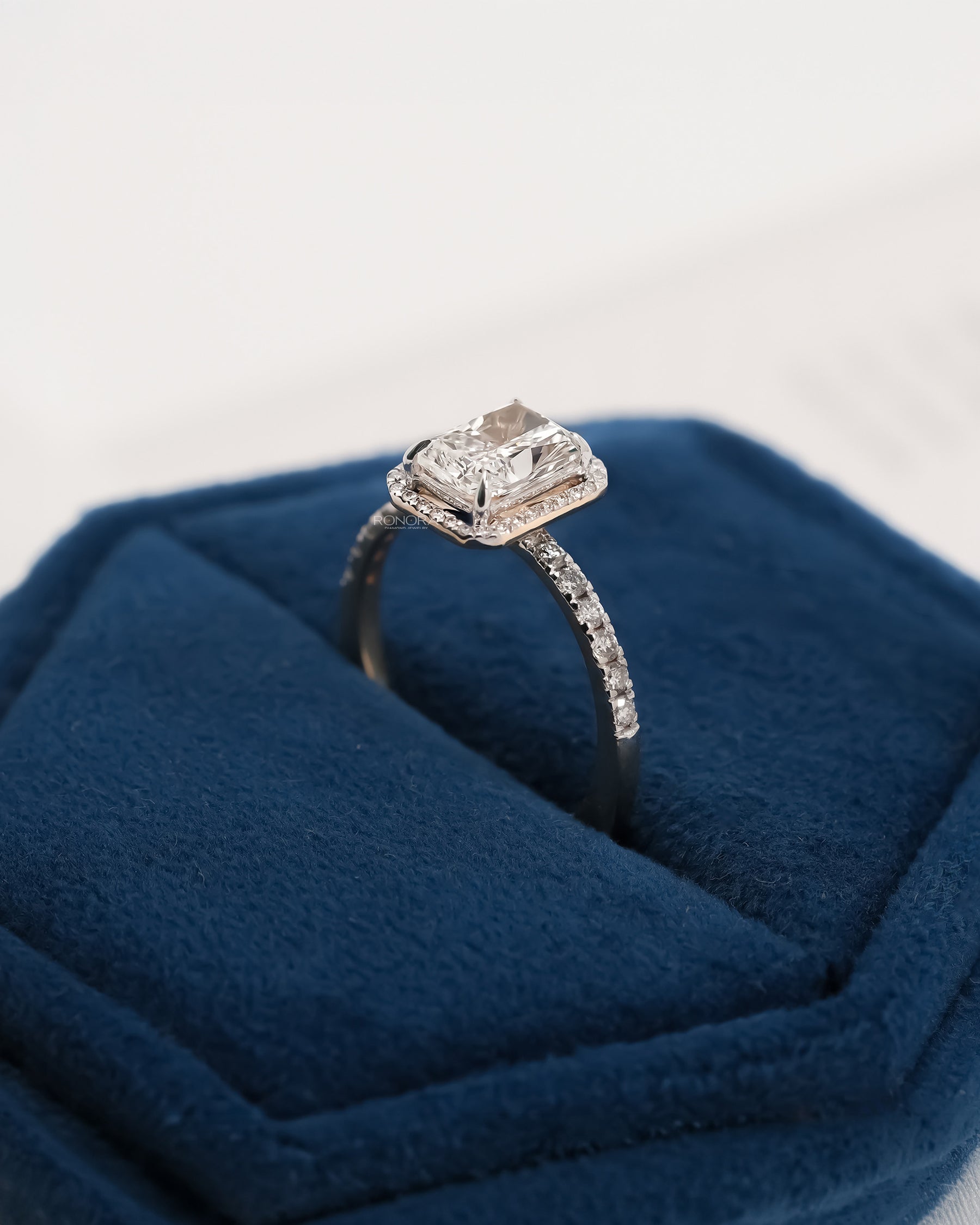 Side profile of radiant lab grown diamond halo ring showing ring setting