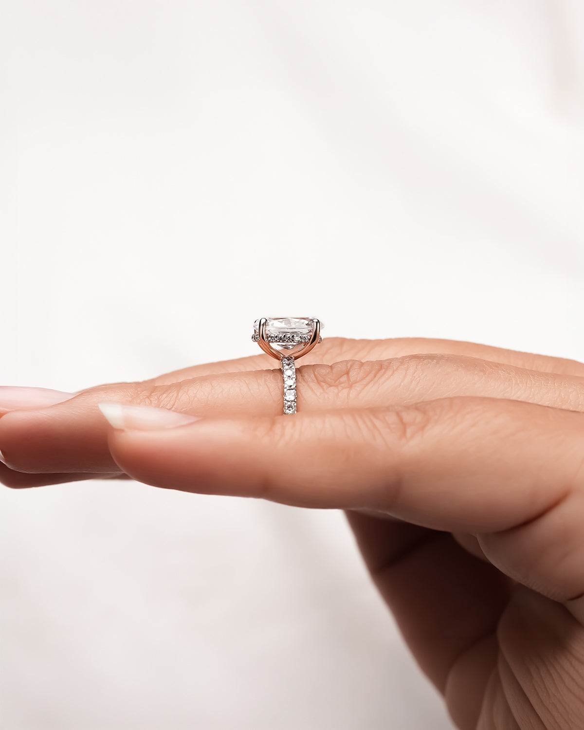 oval moissanite pave ring worn with luxury styling in rose gold