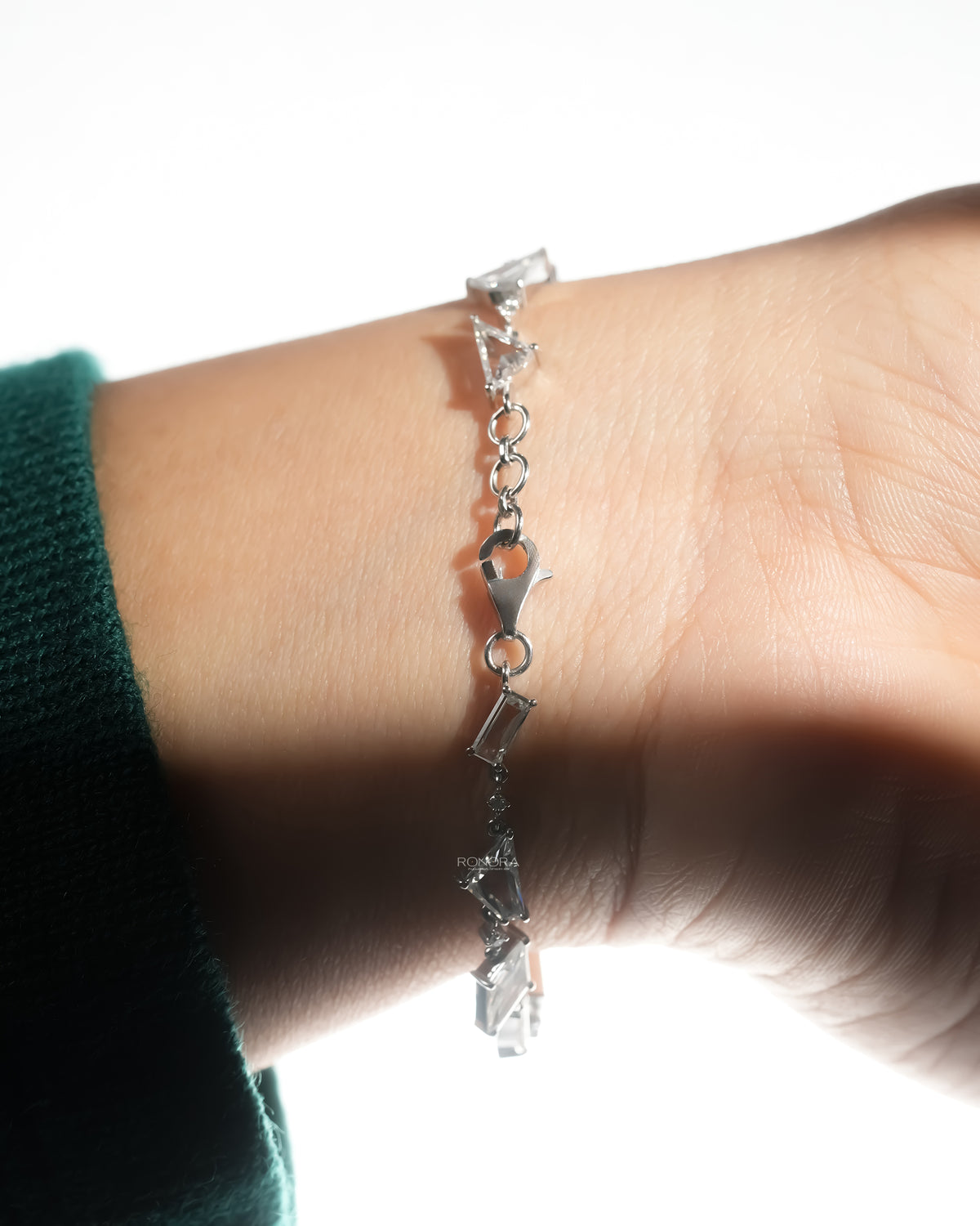 Multi shape lab grown diamond bracelet draped across the wrist
