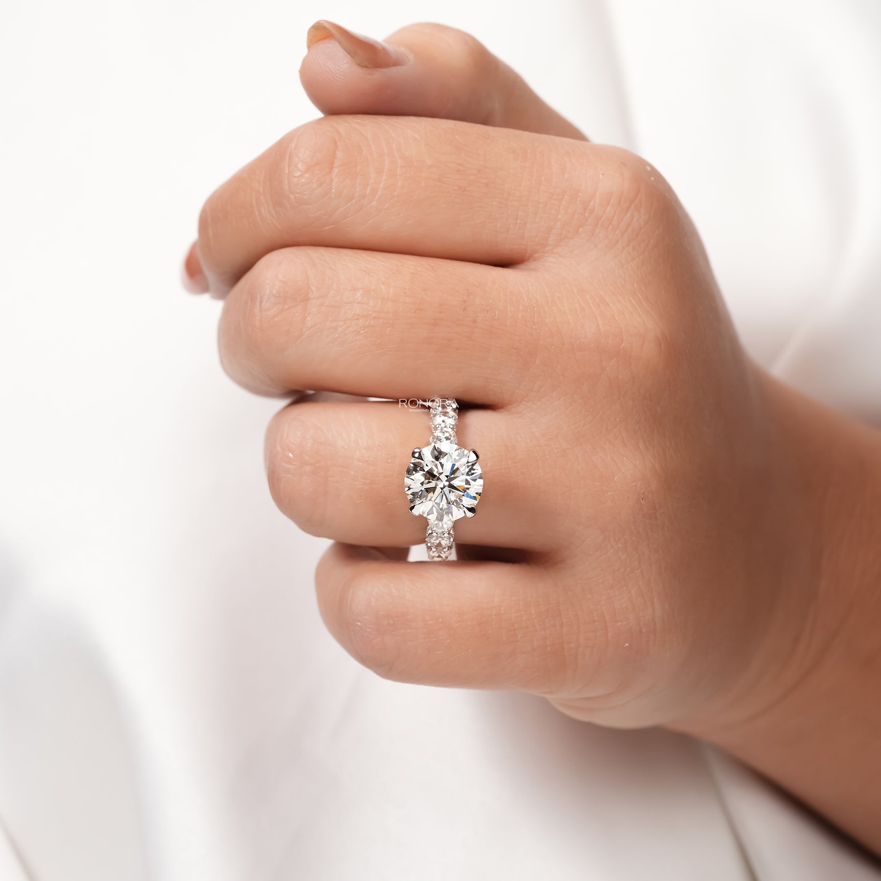 round lab grown diamond vintage halo ring worn on hand in yellow gold