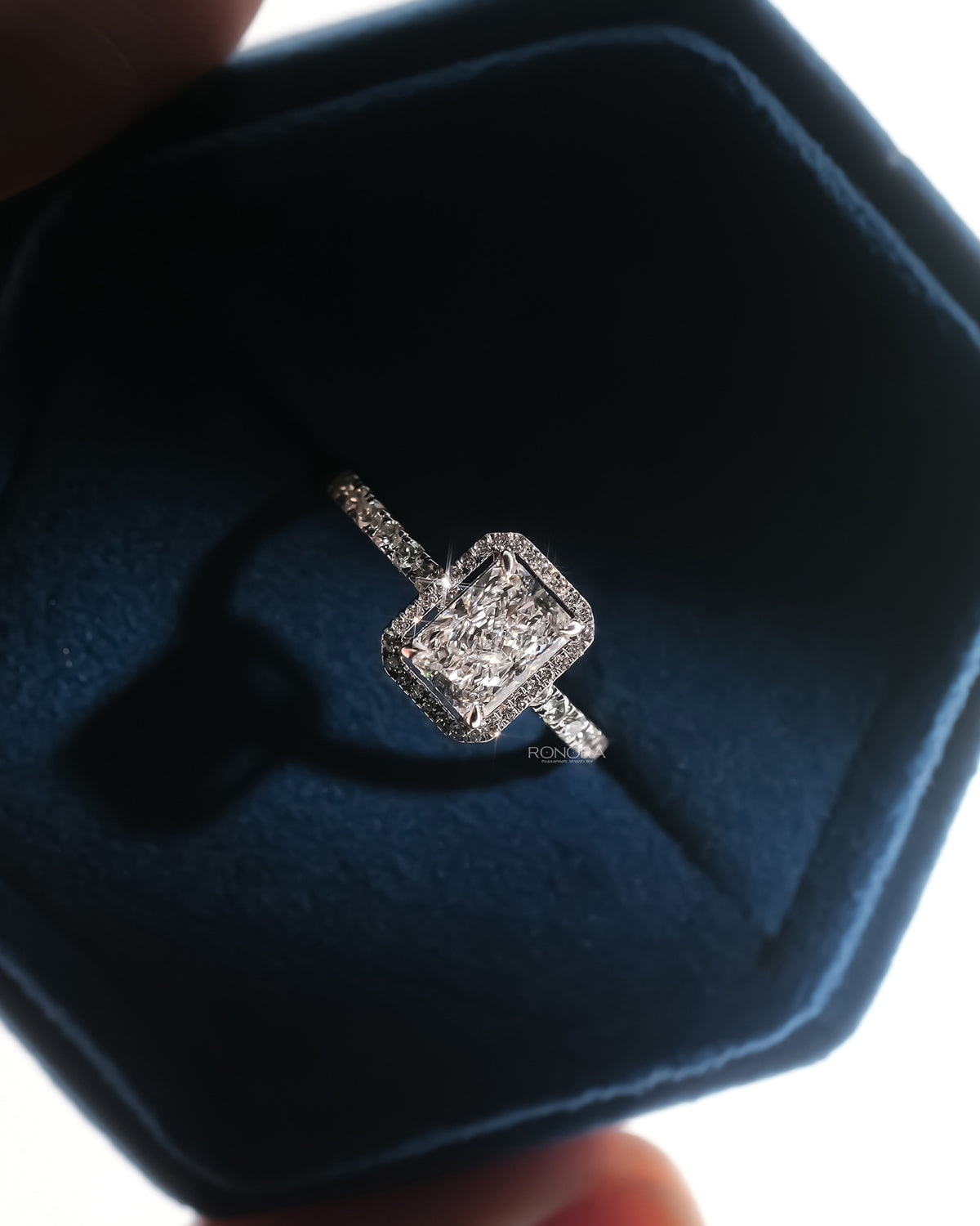 Angled view of radiant lab grown diamond halo ring with halo pave setting