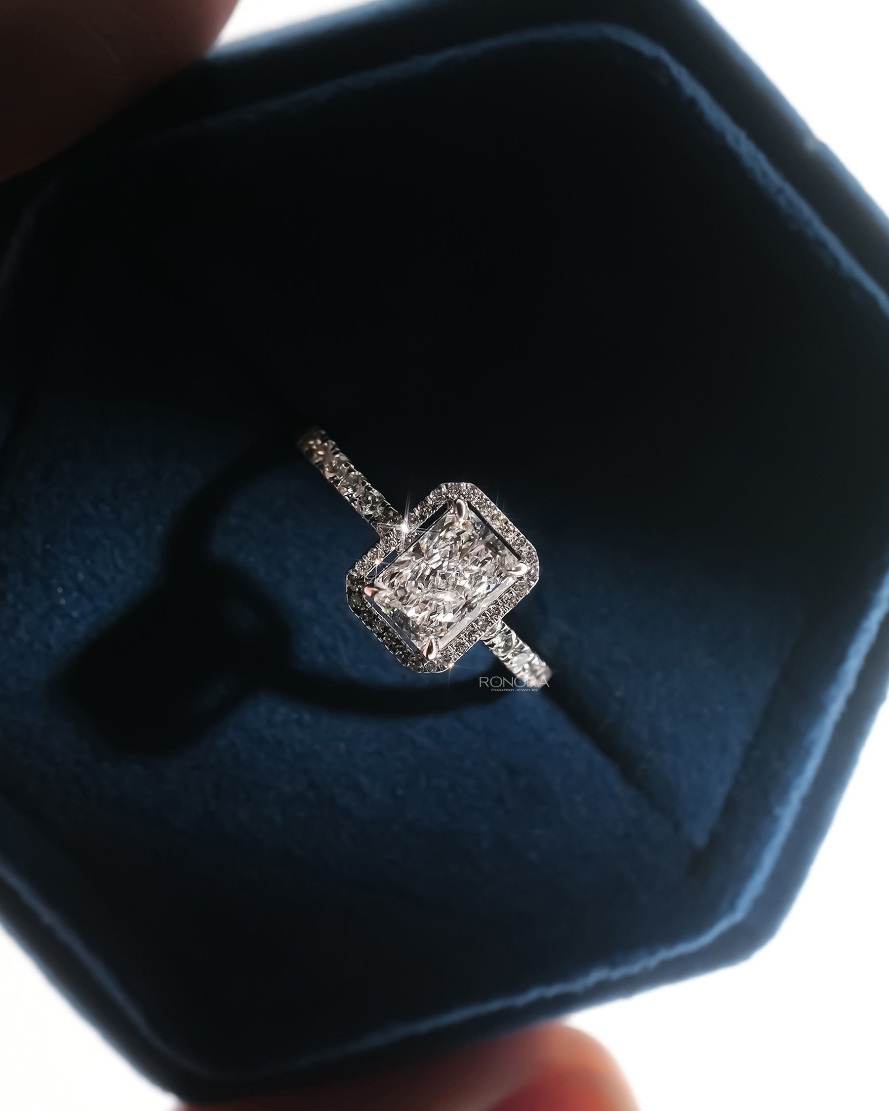Angled view of radiant lab grown diamond halo ring with halo pave setting