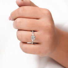 round lab grown diamond side-stone ring worn on hand in white gold