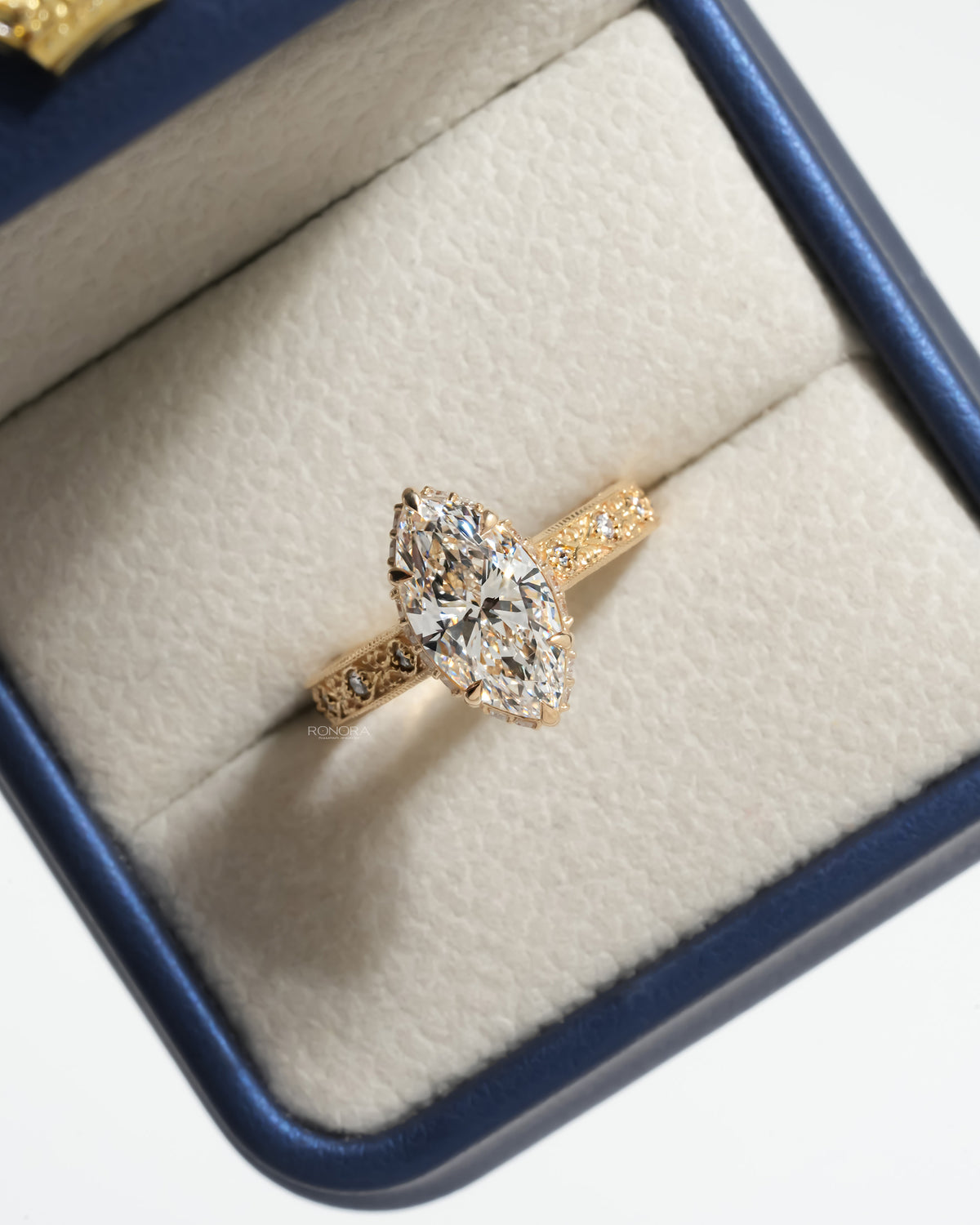 Vintage marquise lab grown diamond ring angled inside an open Ronora box