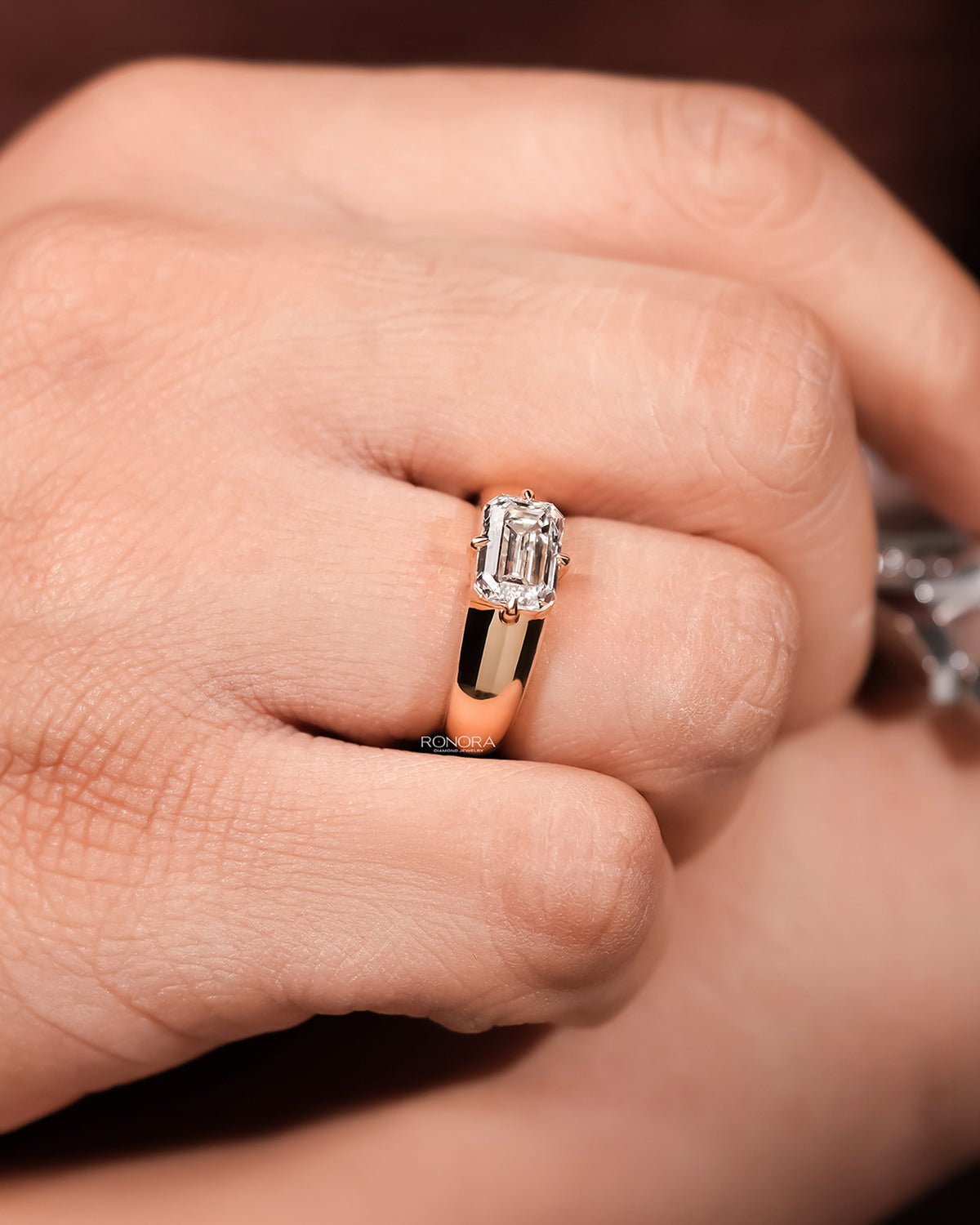 Angled view of emerald lab grown diamond signet ring showing bezel signet setting