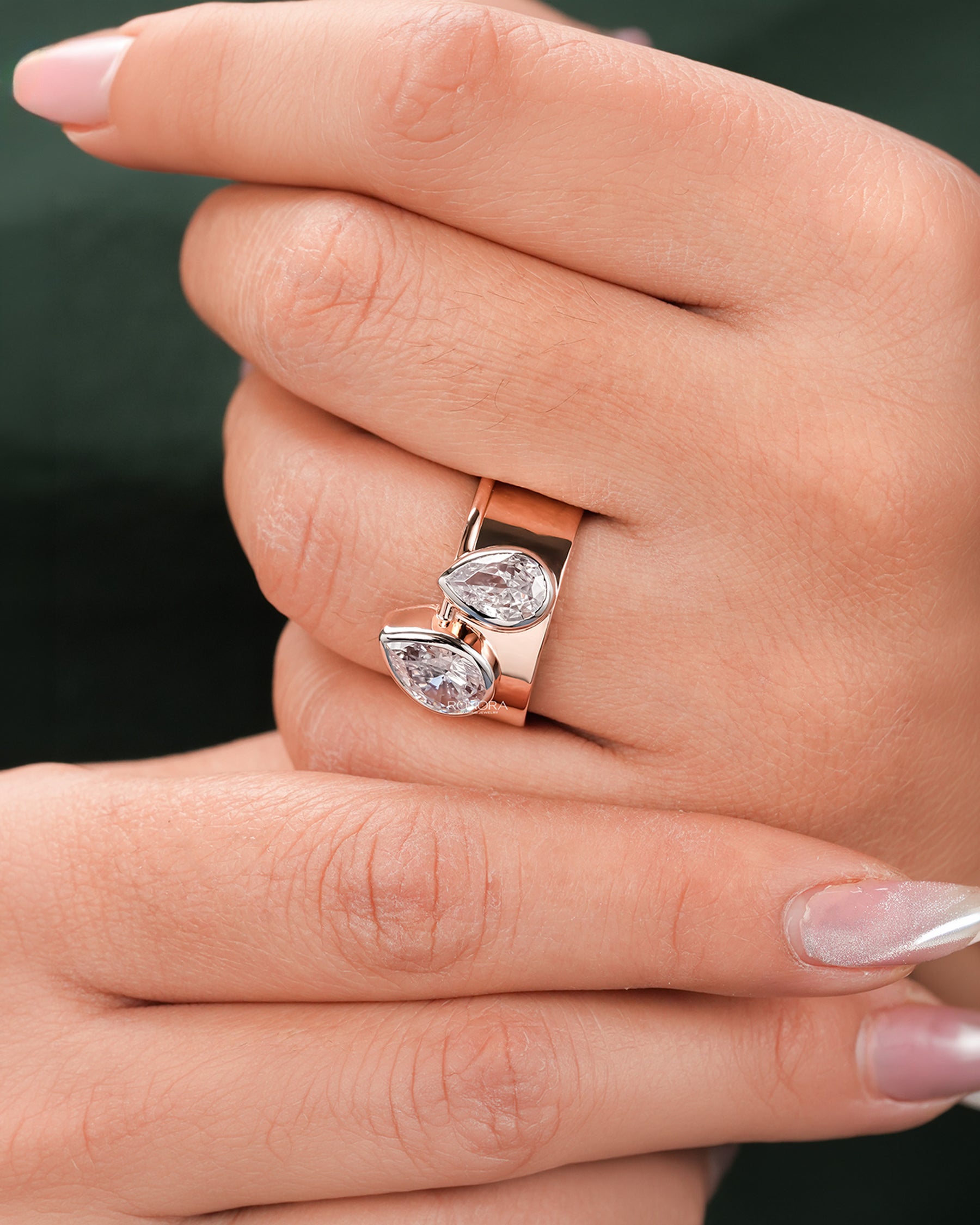 pear lab grown diamond bypass ring worn on hand in rose gold