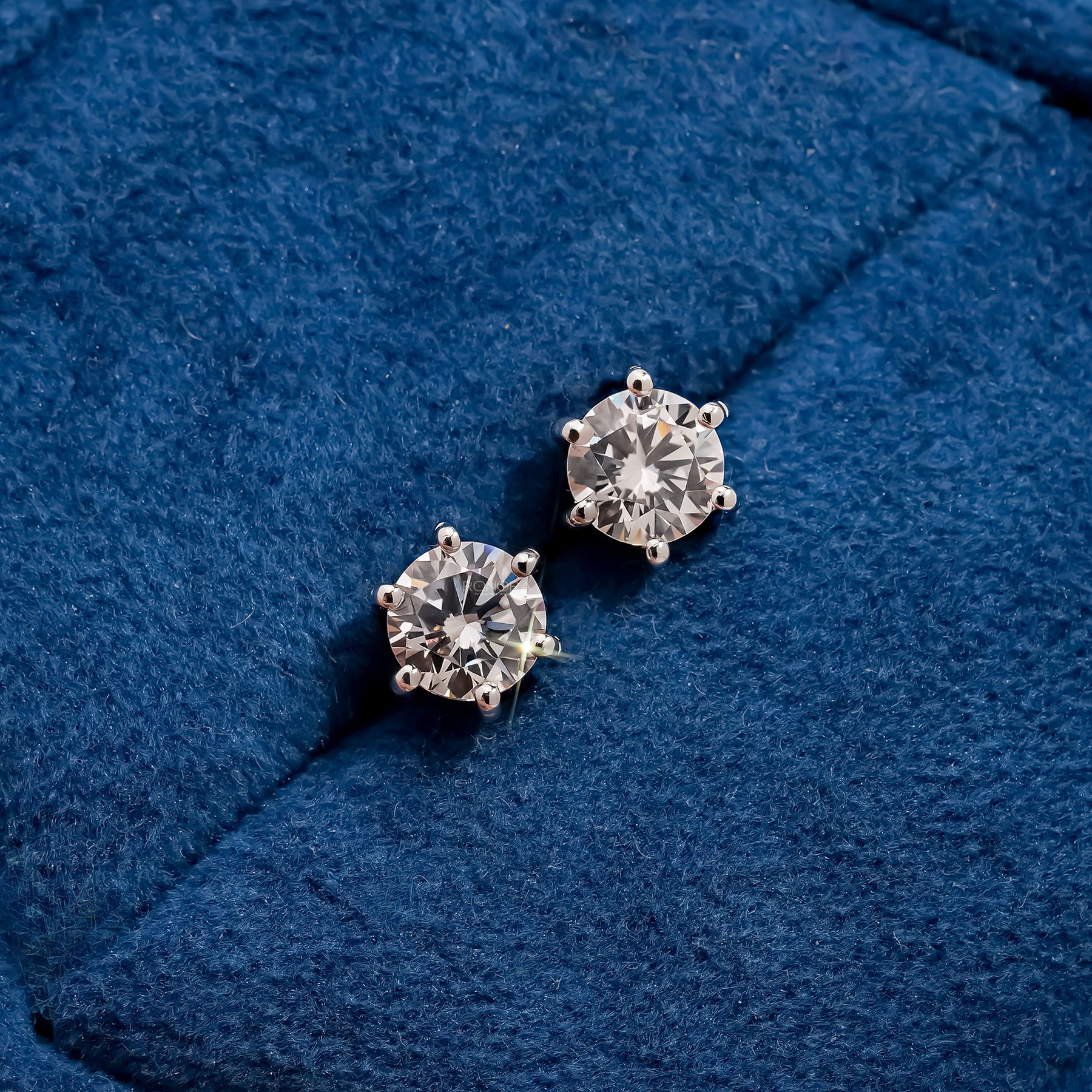 Aurette round lab grown diamond stud earrings on blue velvet