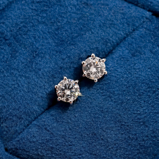 Aurette round lab grown diamond stud earrings on blue velvet