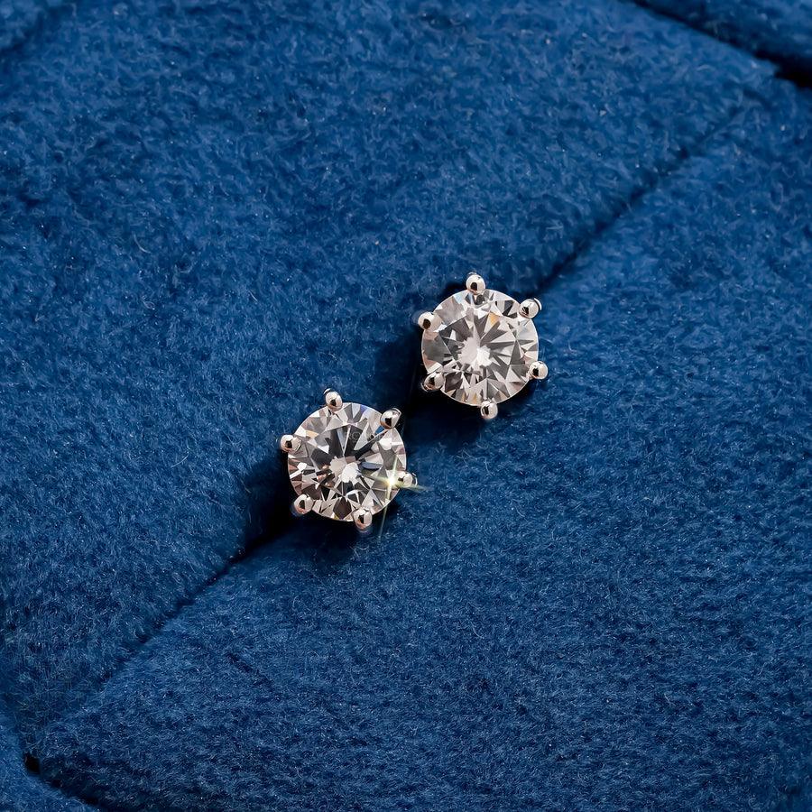 Aurette round lab grown diamond stud earrings on blue velvet