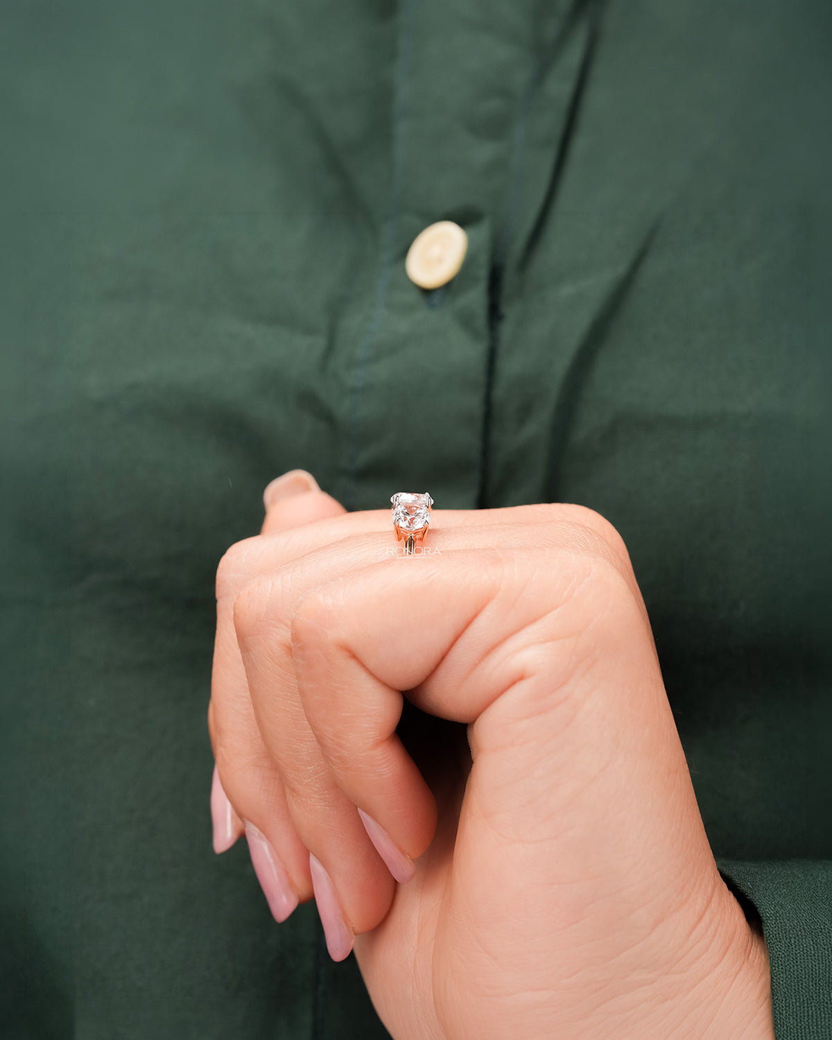 round lab grown diamond three-stone ring worn with luxury styling in rose gold