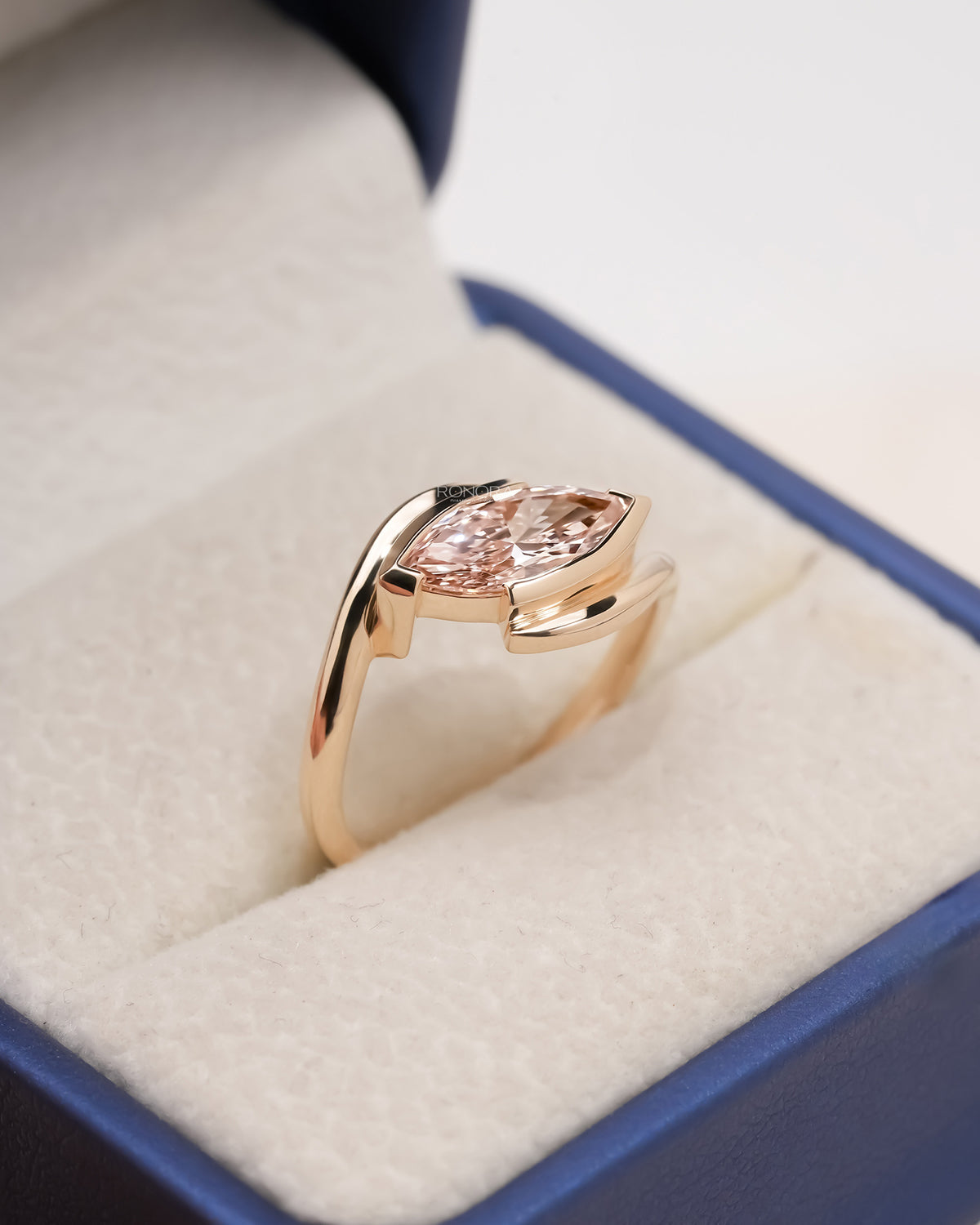 pink marquise lab grown diamond twist ring worn with luxury styling in rose gold