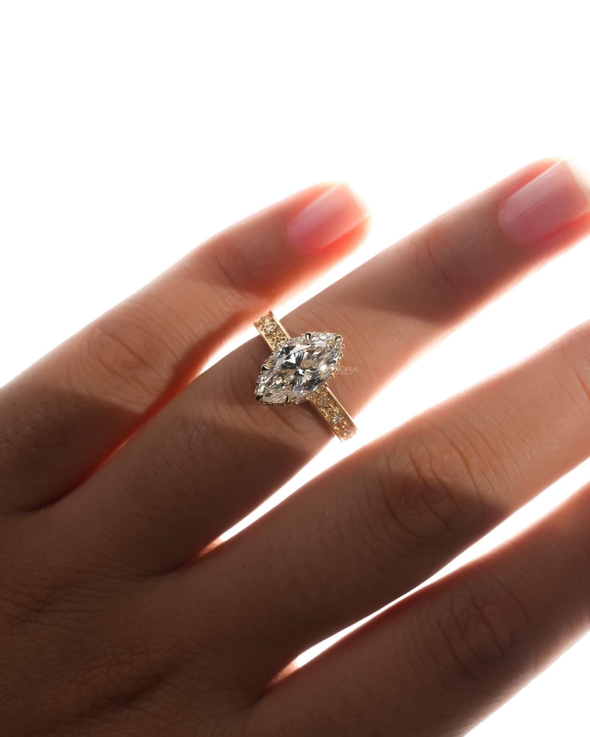 Vintage marquise lab grown diamond ring worn on the hand in yellow gold