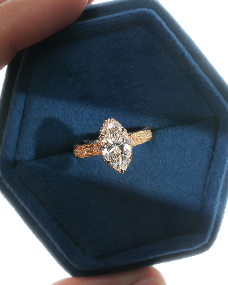 Vintage marquise lab grown diamond ring in yellow gold held in a blue Ronora box