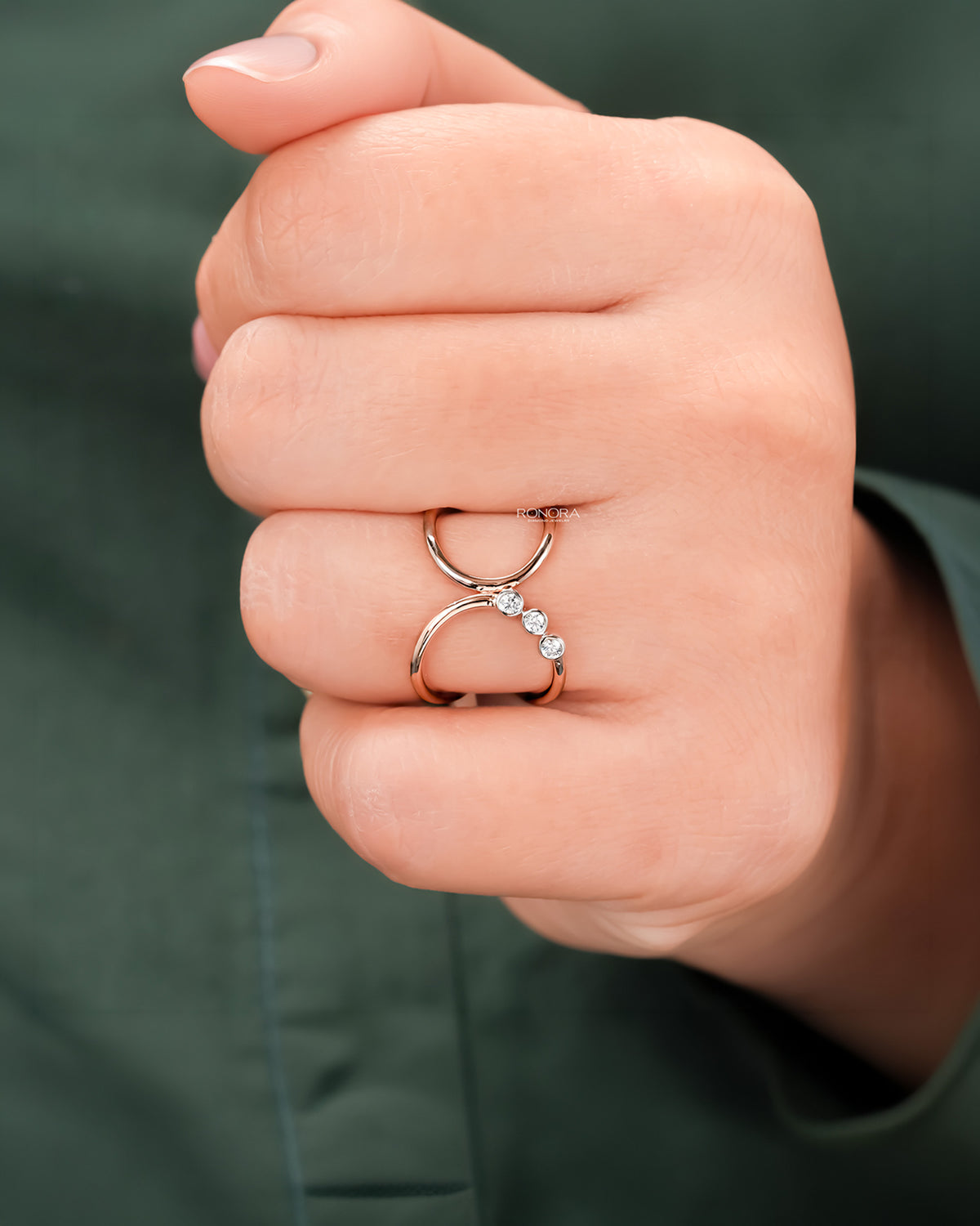 Open lab grown diamond swirl ring worn on hand in rose gold