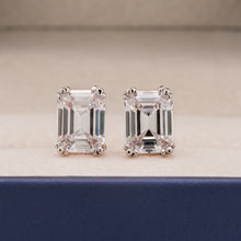 Front view of emerald lab grown diamond stud earrings with prong setting