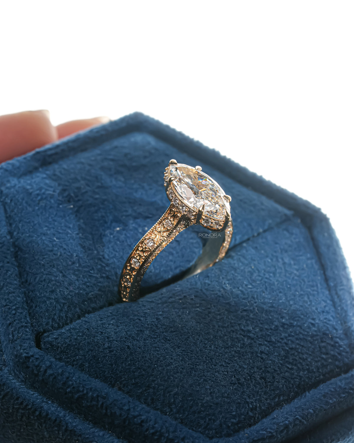 Vintage marquise lab grown diamond ring in a blue Ronora box showing side detailing