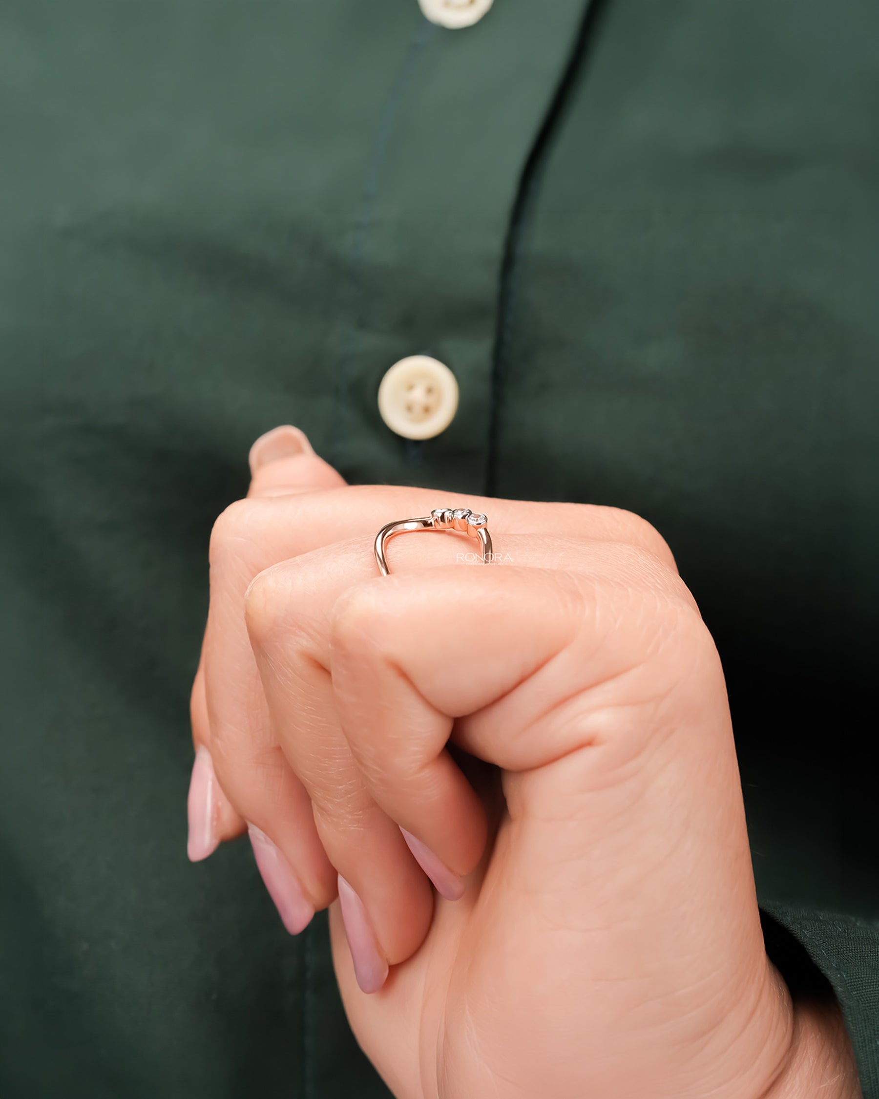 Open lab grown diamond swirl ring worn with white silk