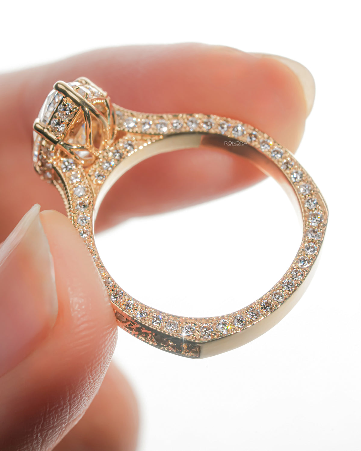 Vintage marquise lab grown diamond ring held to show pave running around the band