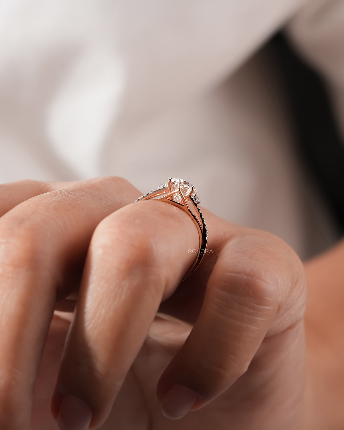 Detail view of oval lab grown diamond halo ring in white gold