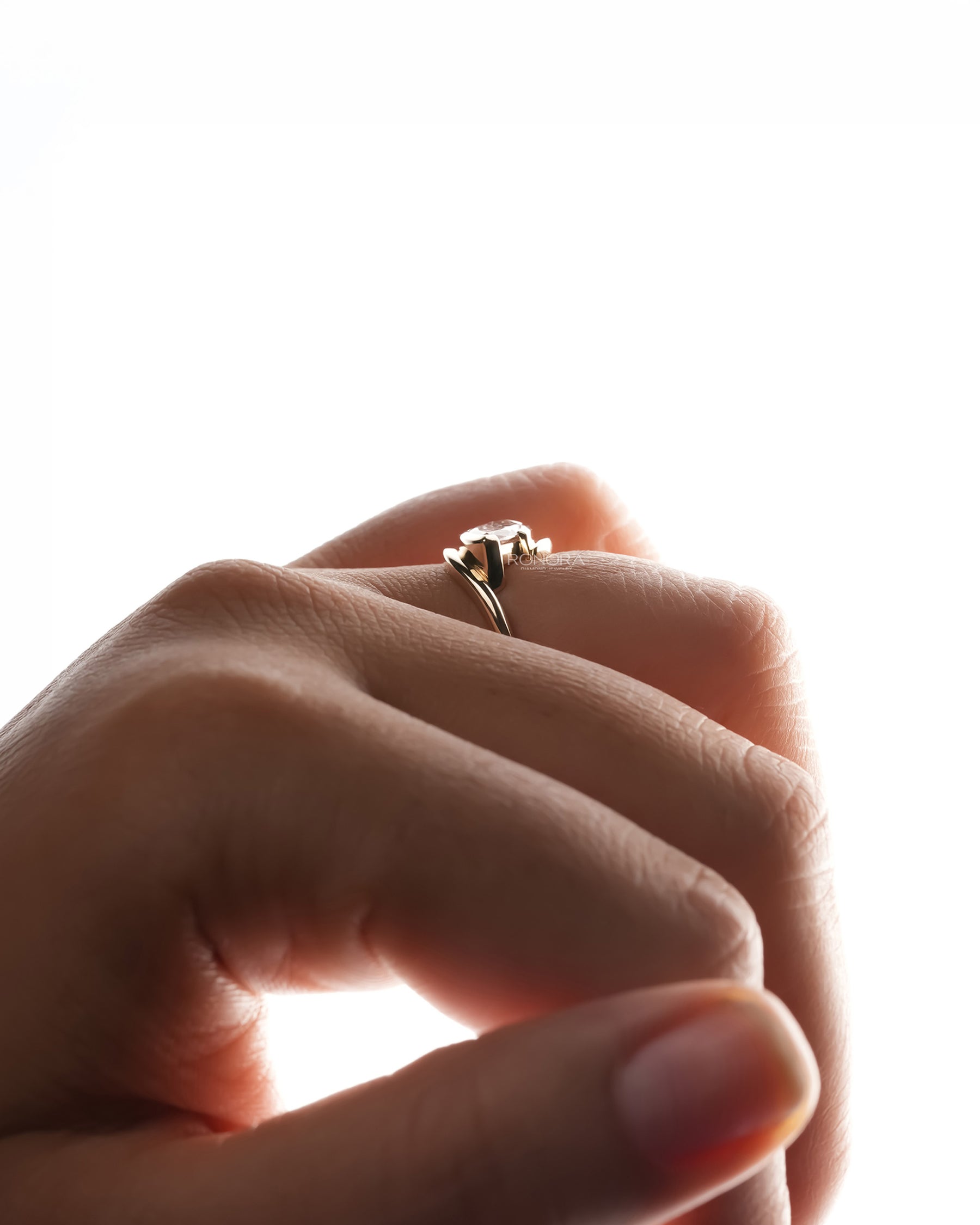 Side profile of pink marquise lab grown diamond twist ring showing ring setting